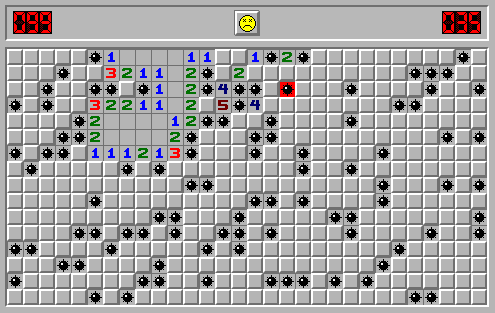 A game of Minesweeper shows a losing score after the player clicked on and detonated a bomb. There is a sad face emoji.